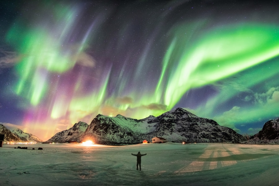 Northern Lights glowing above a snowy winter landscape