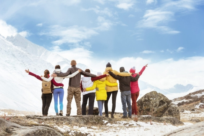 A group of friends celebrating together on a mountain adventure