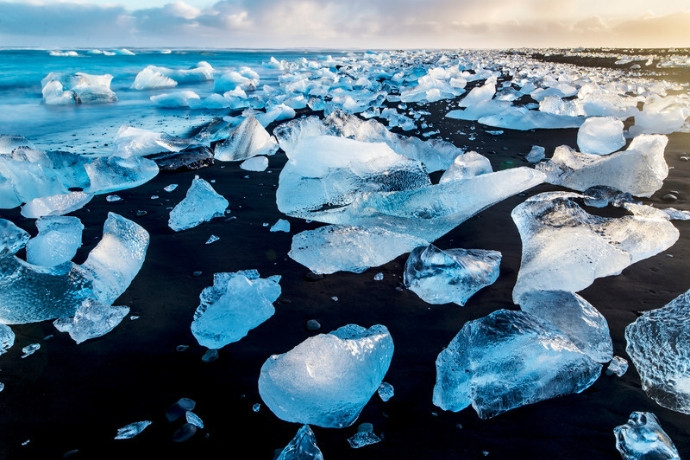 Chunks of glacial ice on the black sand of Diamond Beach, Iceland