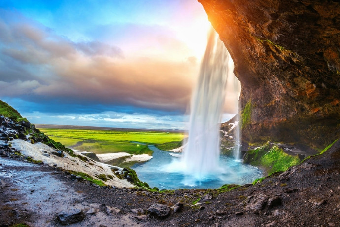 Seljalandsfoss waterfall seen from behind in Iceland